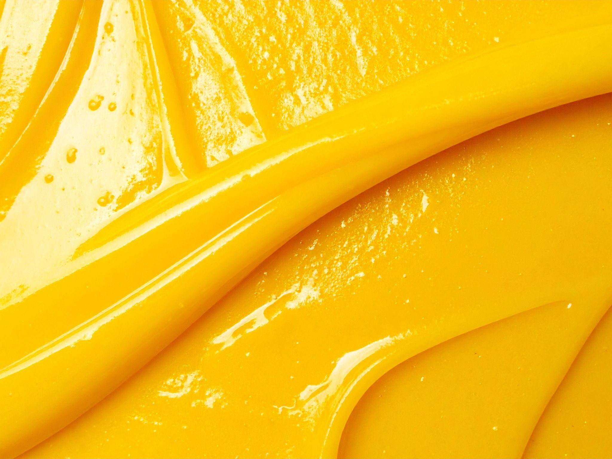 A glossy swirl of golden mango pulp